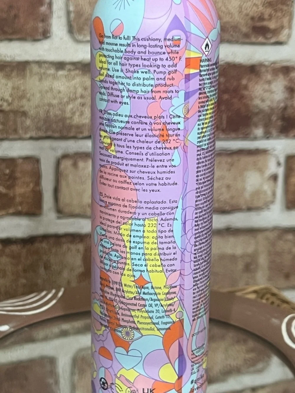 amika body mousse in pink, purple & yellow patterned bottle